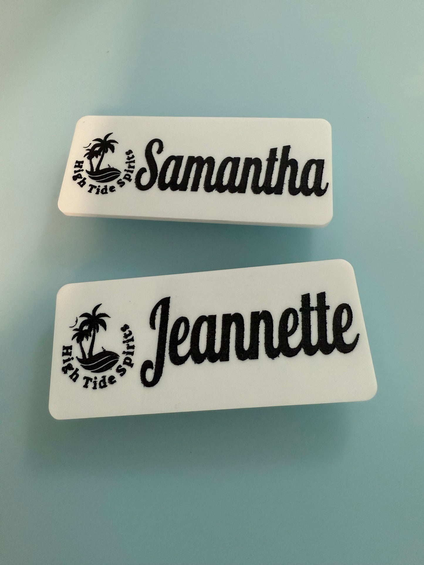 Two name tags with 'Samantha' and 'Jeannette' on a light blue background